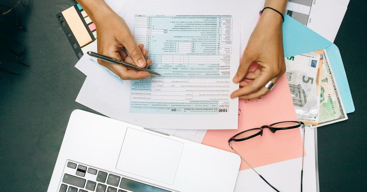 What is ASC 842: accountant reviewing lease documents on a laptop